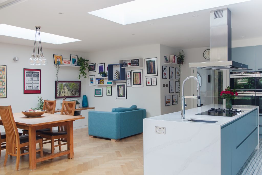 Open-plan kitchen, dining, and living space with gallery wall in Ealing W5 home refurbishment.