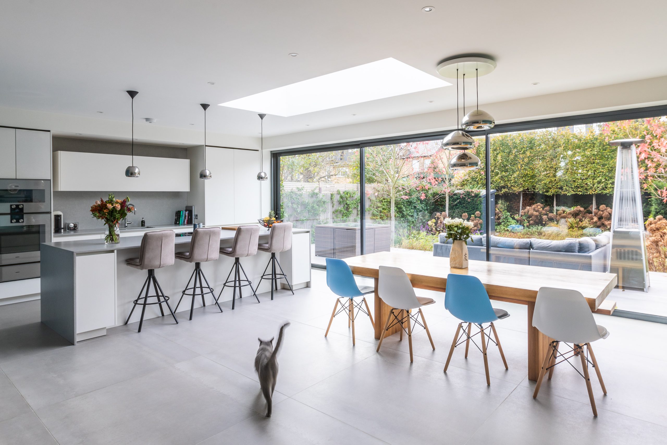 Open-plan kitchen and dining area with large skylight, garden views, and family-friendly layout in Richmond, London home