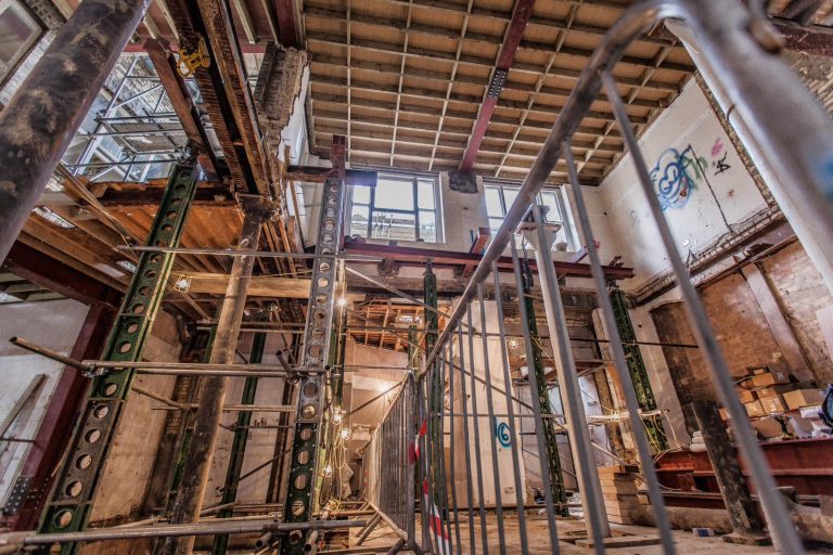 View of an internal structural alteration in progress with temporary propping and exposed steel beams during a London renovation project.